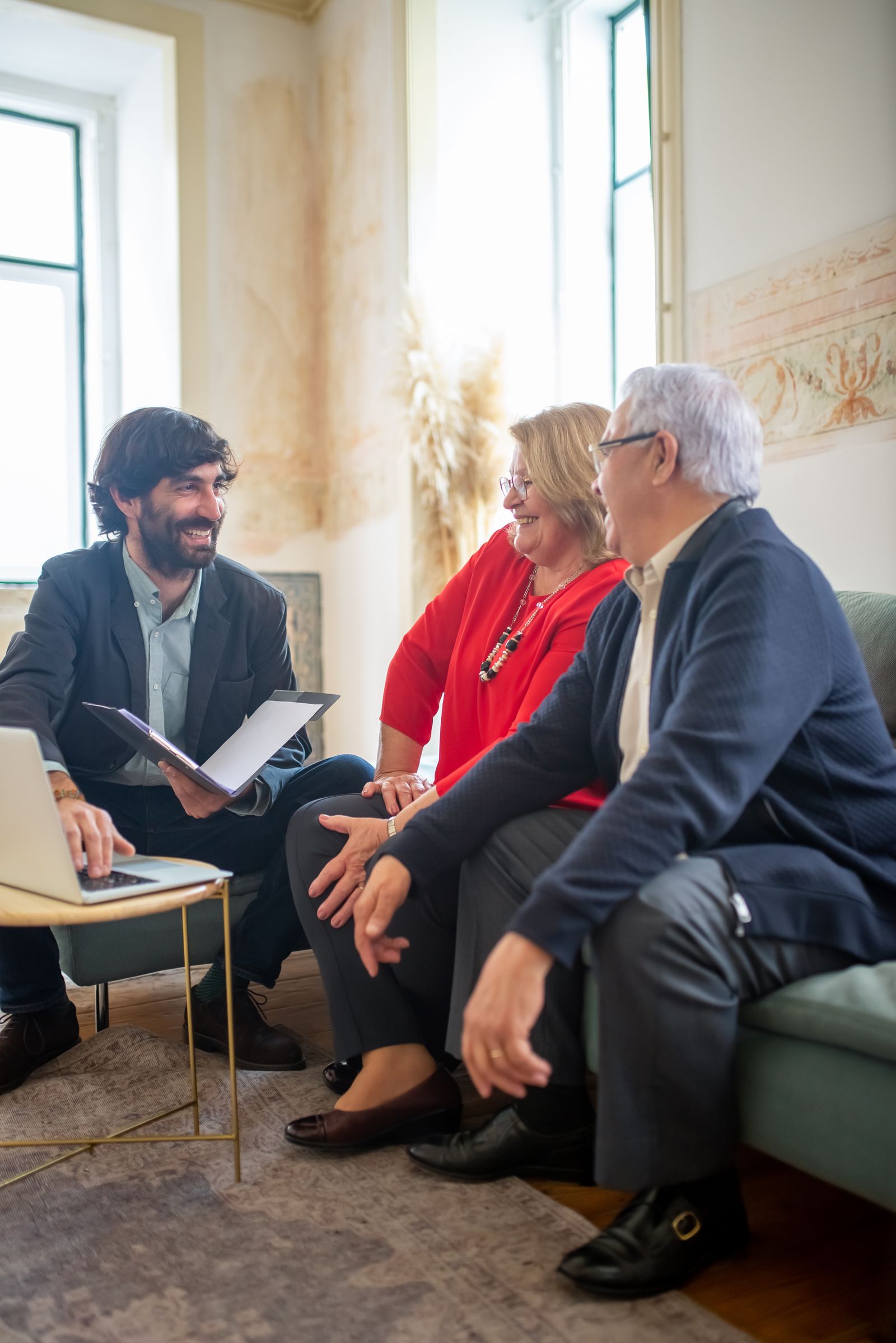An adviser going through a plan with a couple in their home