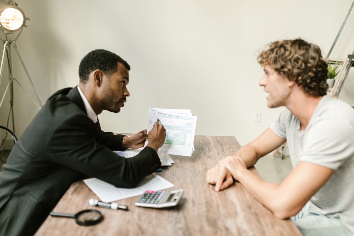 An adviser sitting with a client, going through a plan together